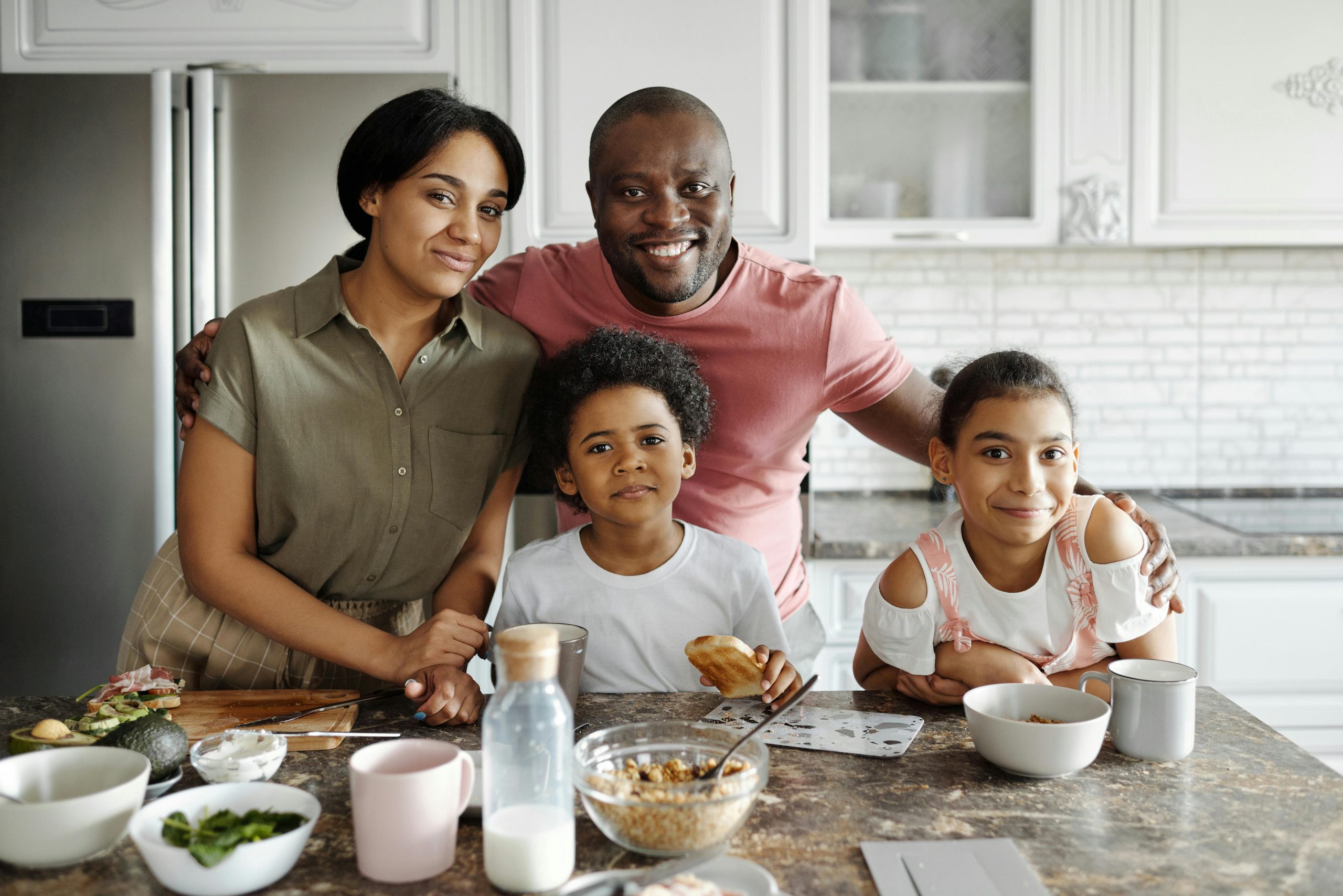 Family smiling together at home, relieved and hopeful